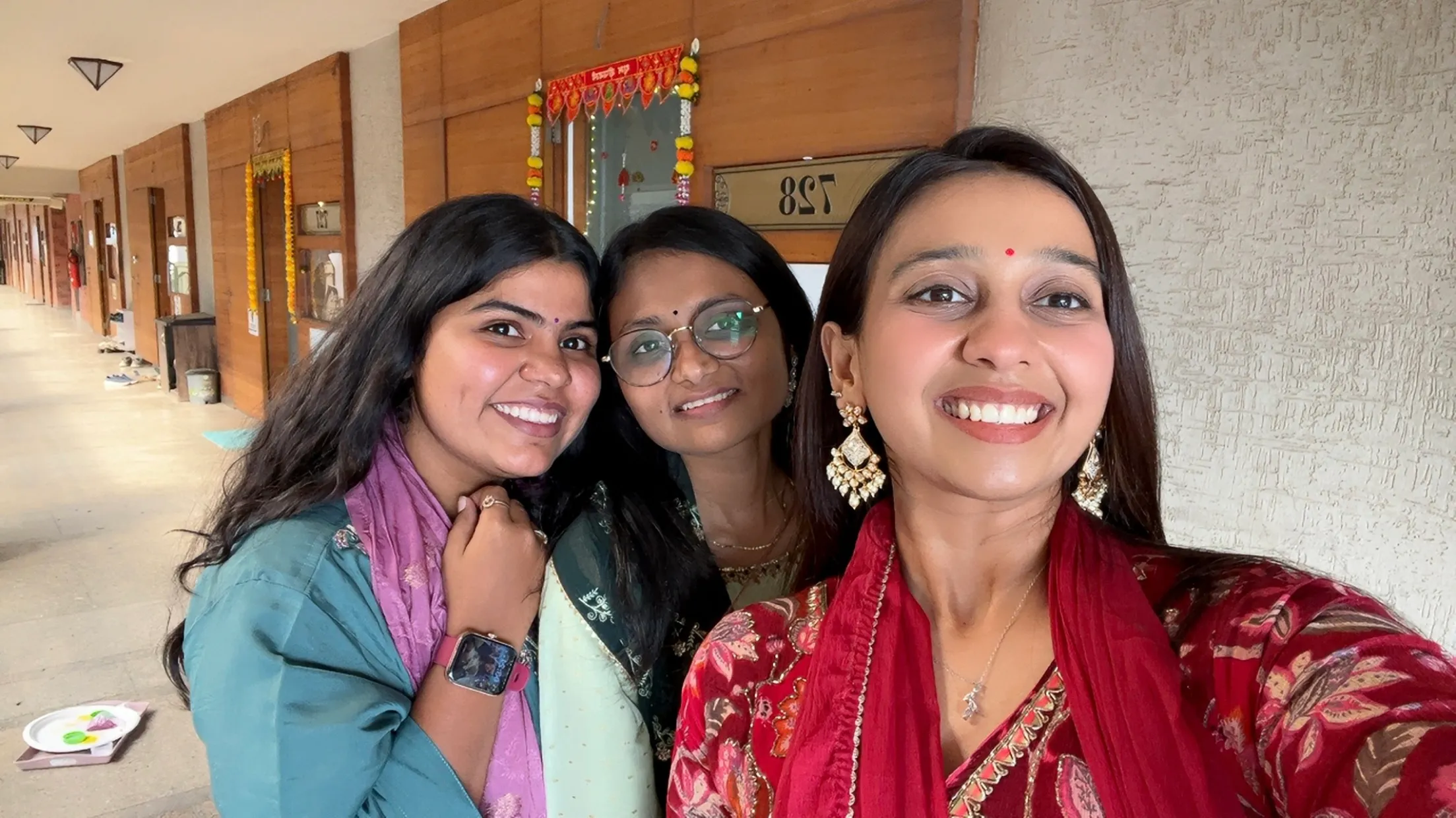 Three teammates in festive dress at the office