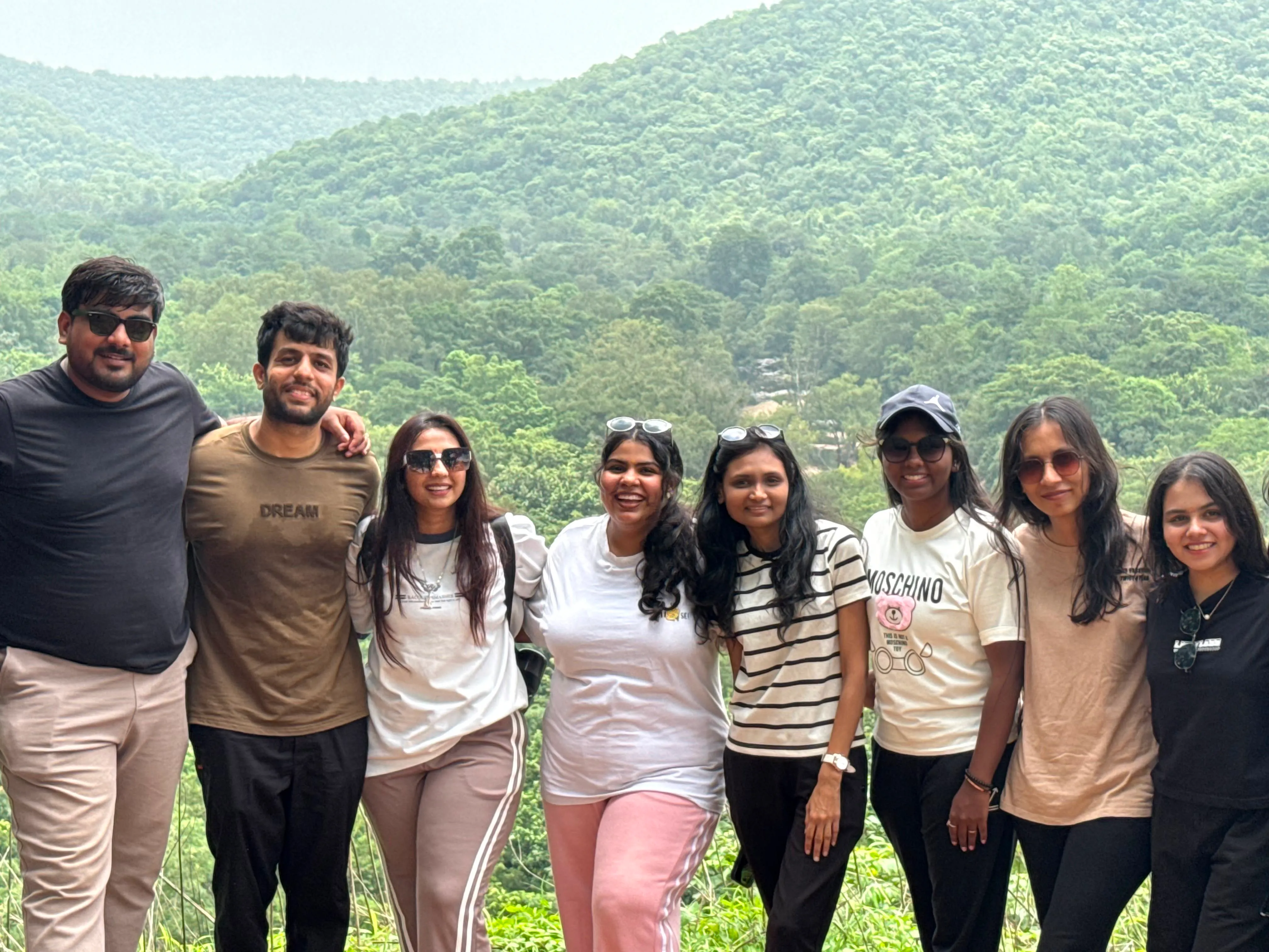 The Haytriox team standing together against green hills