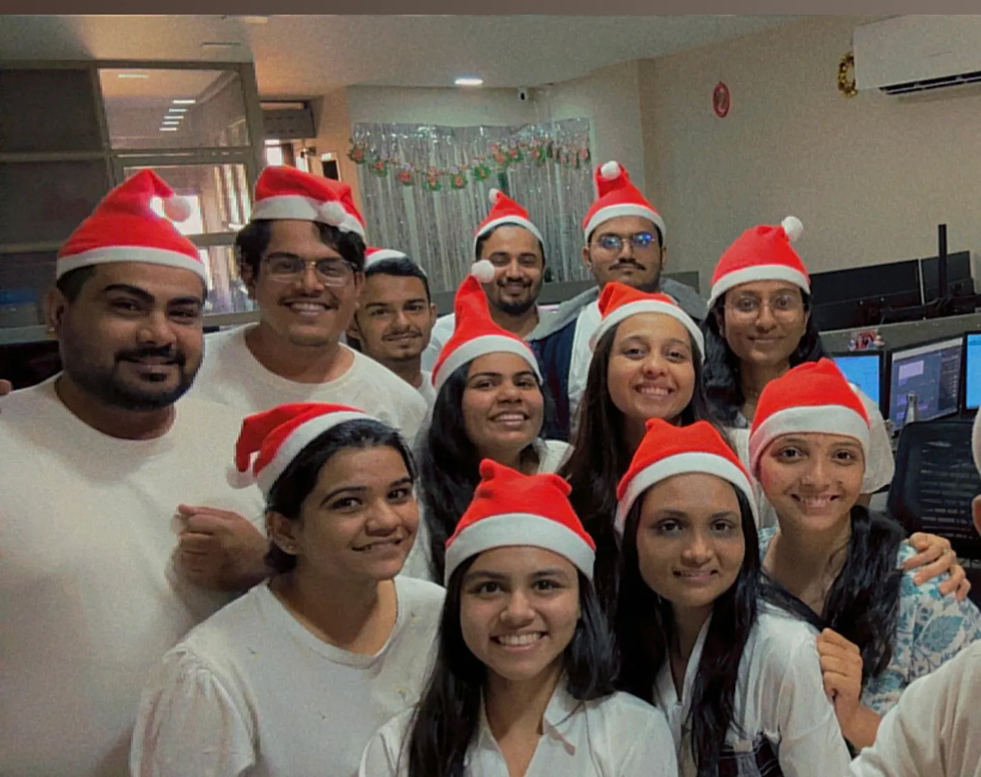 The team celebrating in the office with festive hats